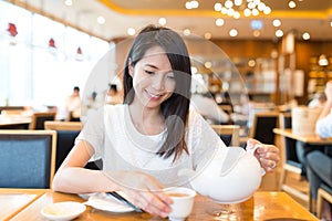 Woman drinking tea in chinese restaurant