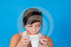 Woman drinking tea or coffee