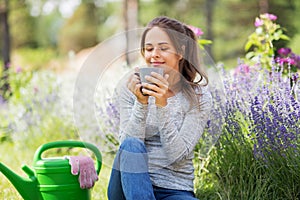 Woman drinking tea or coffee at summer garden