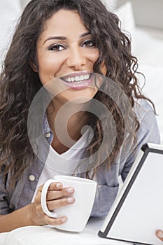 Woman Drinking Tea or Coffee on Tablet Computer