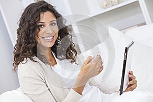 Woman Drinking Tea or Coffee Using Tablet Computer