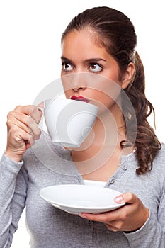 Woman drinking tea from a cup and saucer