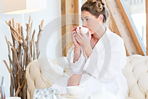 Woman drinking tea in wellness spa