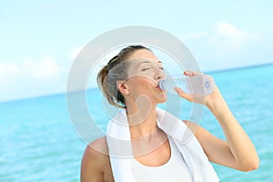 Woman drinking water after excercising