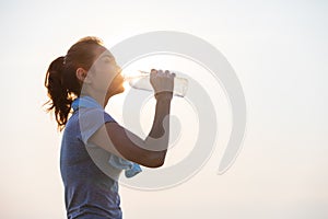 Woman drinking water after exercise