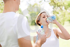 Woman drinking water after exercise