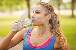 Woman drinking water in park