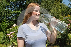 Woman drinking water during summer