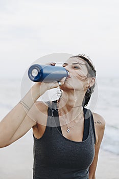 Woman drinking water after a workout