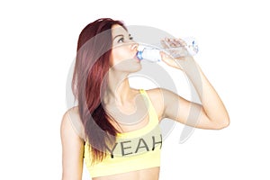 Woman drinking water after workout on white background. Sport and fitness.