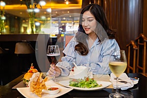 Woman drinking wine in the restaurant