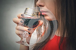 Woman drinking wine from wineglass.