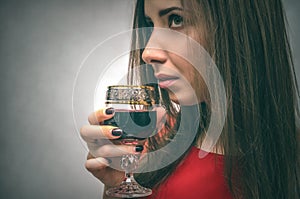 Woman drinking wine from wineglass.