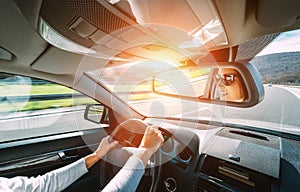 Woman drive a car reflects in back view mirror photo