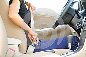 Woman driver buckle up the seat belt photo
