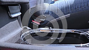 A woman driver fastening and unfastening a seatbelt, safety belt, car safety and driver protection concept