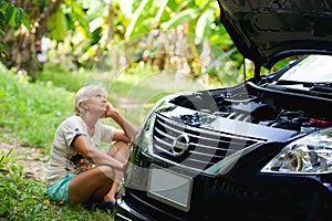 Woman driver on the forest road waiting help