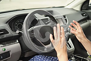 Woman driver hand honking her car horn to prevent accident. Driving safety concept