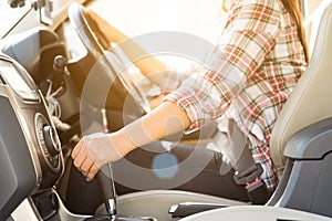 Woman driver hand shifting or changing the gear stick