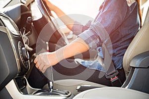 Woman driver hand shifting or changing the gear stick