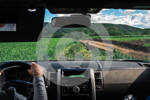 Woman Driver hands on the steering wheel inside of a car, field dirt road, offroad, off road, vrong turn, navigation lost,