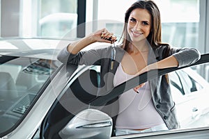 Woman Driver Holding Car Keys. Car Showroom.
