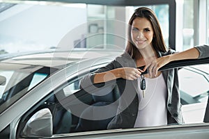 Woman Driver Holding Car Keys. Car Showroom.