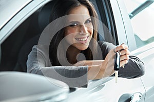 Woman Driver Holding Car Keys siting in Her New Car. photo