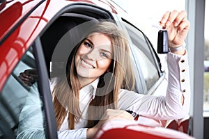 Woman Driver Holding Car Keys siting in New Car