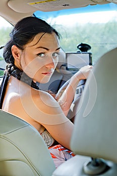 Woman driver looking back