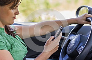 Woman driver reading a text message