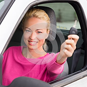 Woman driver showing car keys.