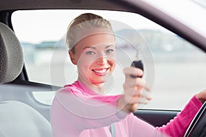 Woman driver showing car keys.