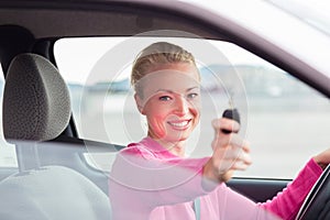 Woman driver showing car keys.