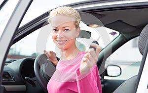 Woman driver showing car keys.