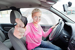 Woman driver showing car keys.