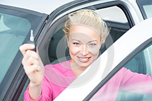 Woman driver showing car keys.