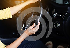 Woman driver showing new car keys before driving her car