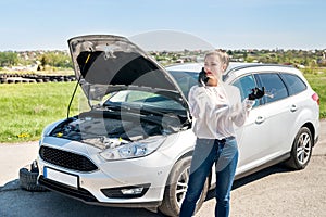 Woman driver with spanners calling for help