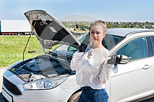 Woman driver with spanners calling for help