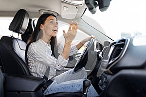 Woman driver stuck in traffic jam gesturing with hand, screaming