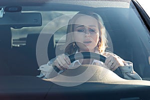 Woman drives her car for the first time.  Inexperienced driver in stress and confusion after an accident