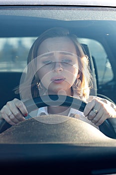 Woman drives her car for the first time, tries to avoid a car accident, is very nervous and scared, worries, clings tightly to the