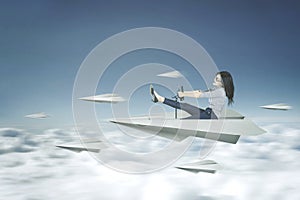 Woman drives a paper plane