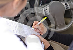 Woman drivier signing a legal document