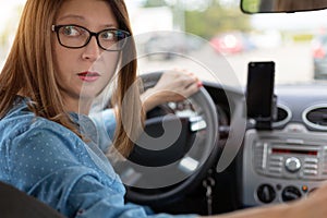 A woman driving the car backwards