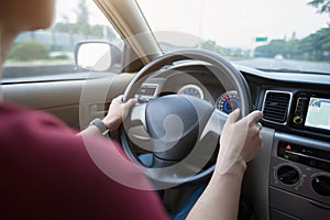 Woman driving car on city road