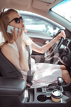 Woman driving car in dress, stands in parking lot, looks in rearview mirror, makes phone calls and listens voice