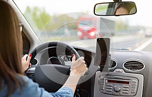 A woman driving a car on a fast road