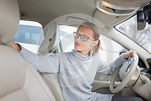 Woman driving a car - female driver at a wheel of a modern car,